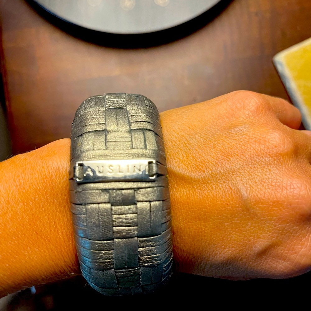 silver/grey thick vegan leather bangle. gently used. great condition.